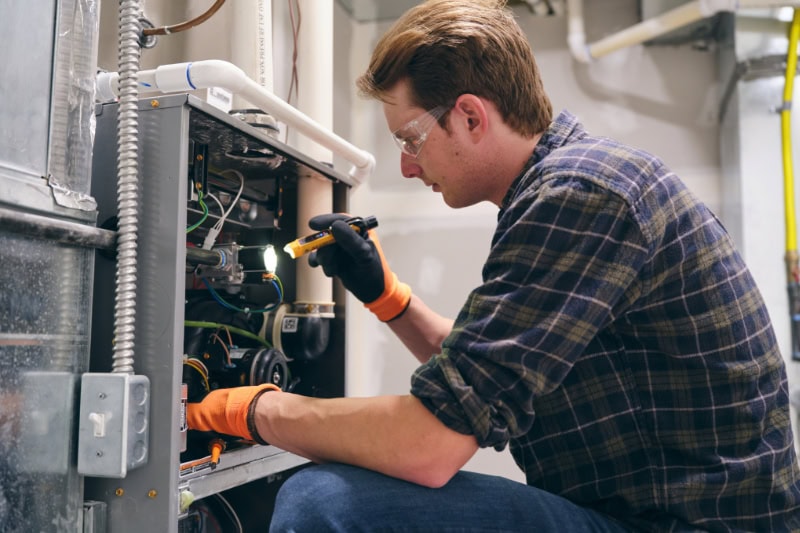 Technician Inspecting Unit.