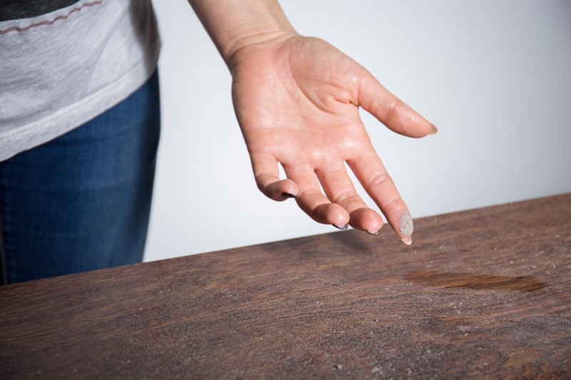 Close-up of dust on woman finger